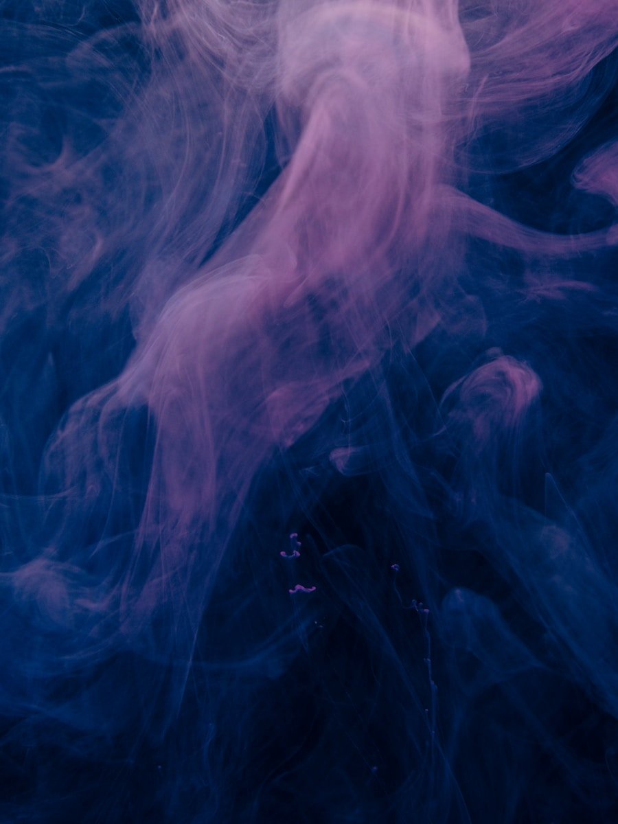 a blue and pink background with smoke coming out of it